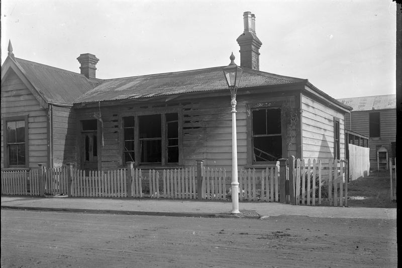 House after fire showing damaged walls, windows and roof